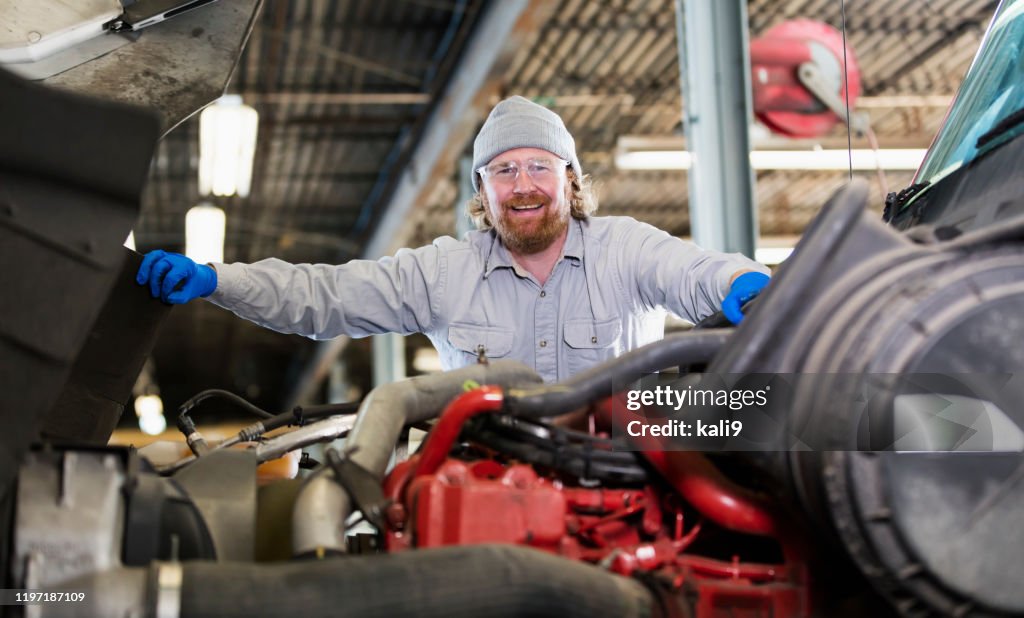 Mechanic repairing semi-truck