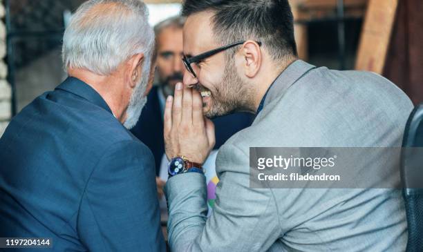 business colleagues whispering on a meeting - gossip stock pictures, royalty-free photos & images