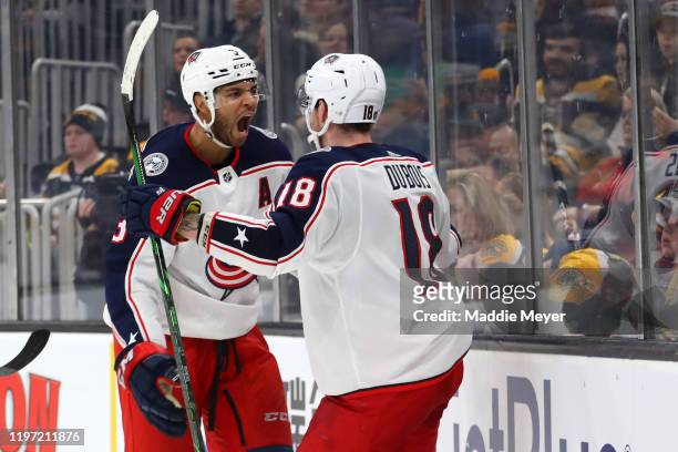 Pierre-Luc Dubois of the Columbus Blue Jackets celebrates with Seth Jones after scoring a goal to defeat the Boston Bruins 2-1 in overtime at TD...