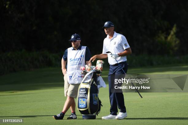 Matt Kuchar of the United States and his caddie John Wood look on during the first round of the Sentry Tournament Of Champions at the Kapalua...