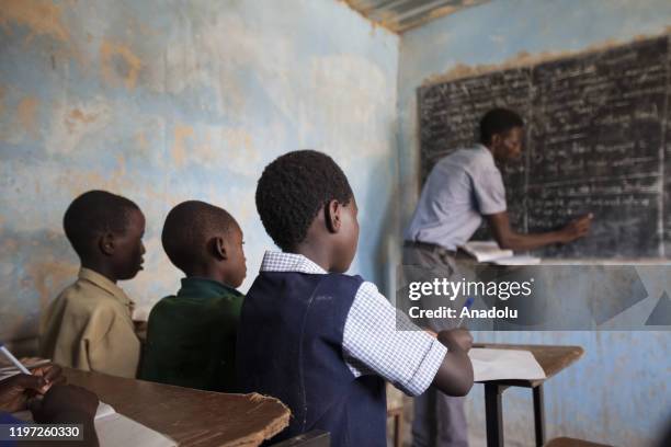 Teacher and students are seen during a lesson at a classroom of the makeshift schools to access affordable school lessons as they contend with a...