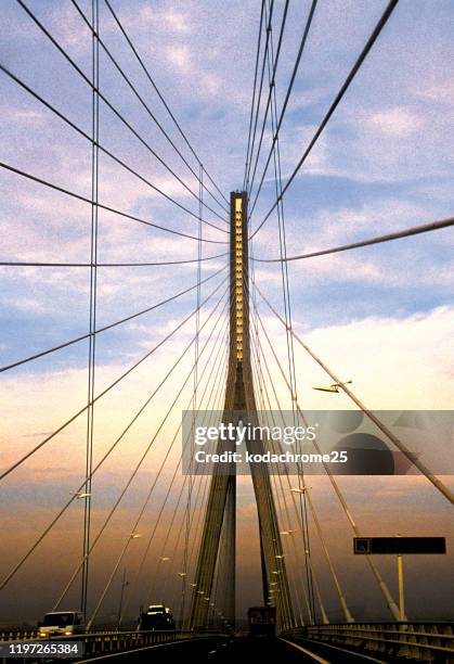 the pont de normandie is a cable-stayed road bridge that spans the river seine linking le havre to honfleur in normandy, northern france. - pont de normandie stock pictures, royalty-free photos & images