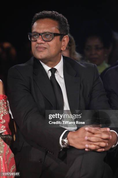 Fashion designer Naeem Khan watches his runway show at the 13th Annual Design Care Benefiting The HollyRod Foundation - Inside on July 23, 2011 in...