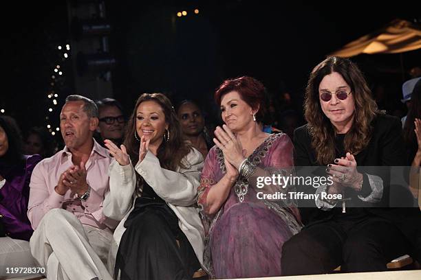 Guest, actress Leah Remini, TV personality Sharon Osbourne and recording artist Ozzy Osbourne watch the Naeem Khan runway show at the 13th Annual...
