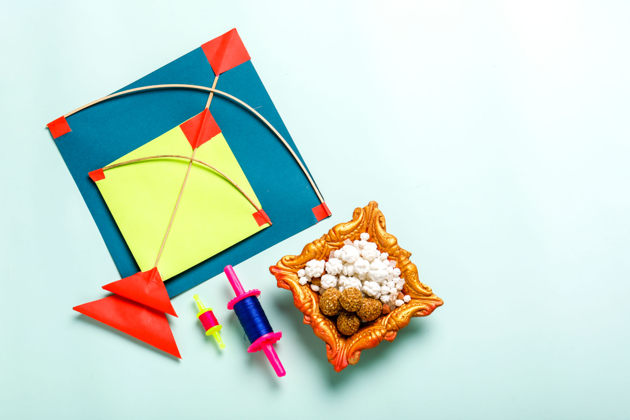 Celebrate Indian festival makar sankranti with colorfull kite,sesame seed ball,tilgul and chakri with background Celebrate Indian festival makar sankranti with colorfull kite,sesame seed ball,tilgul and chakri with background