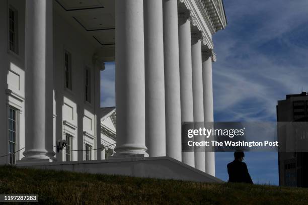 Woman walks past the Virginia State Capitol February 08, 2019 in Richmond, VA. The top three Democrats in the Virginia legislature, Virginias Gov....