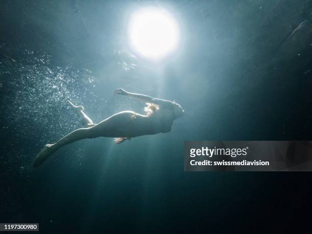 underwater shot of woman diving in mexican cenote - deep hole stock pictures, royalty-free photos & images