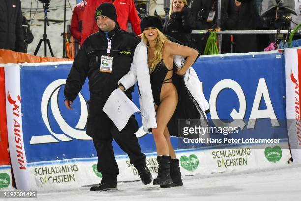 Streaker Kinsey Wolanski wearing a swimming costume holds up a RIP Kobe Bryant banner during the Audi FIS Alpine Ski World Cup - Men' s Slalom on...