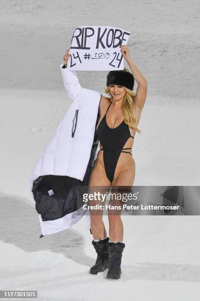 Streaker Kinsey Wolanski wearing a swimming costume holds up a RIP Kobe Bryant banner during the Audi FIS Alpine Ski World Cup - Men' s Slalom on...