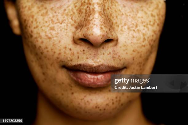 close up of middle of a mixed race woman's face with freckles - woman face close up stock pictures, royalty-free photos & images