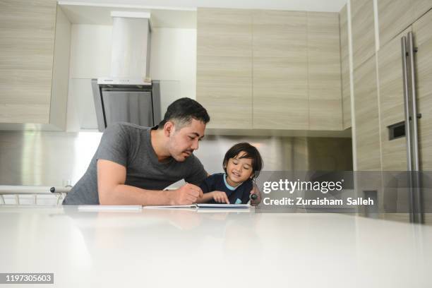 asian family learn together at home - malay archipelago stock pictures, royalty-free photos & images