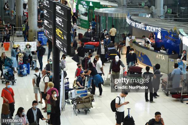 Tourists wearing protective masks walk at Suvarnabhumi Airport in Bangkok, Thailand, 29 January 2020.