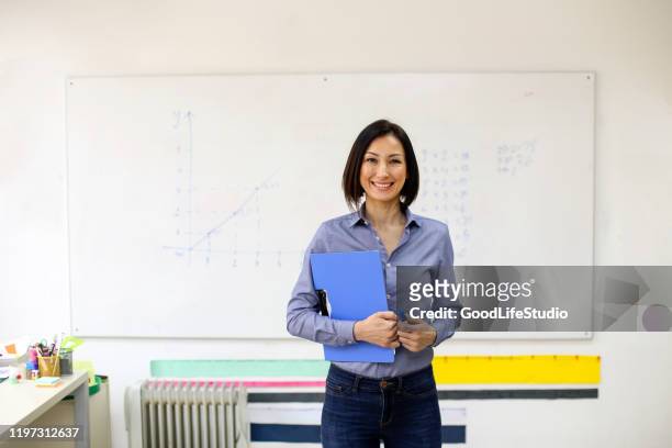 smiling female school teacher - mathematician stock pictures, royalty-free photos & images