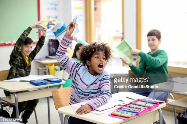 chaos in a classroom - aggression school stock pictures, royalty-free photos & images