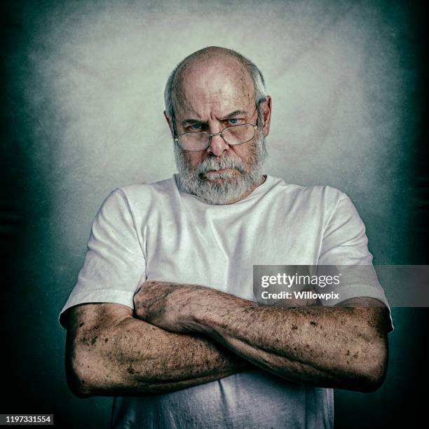 angry grumpy scolding arms crossed senior adult man - grumpy man stock pictures, royalty-free photos & images