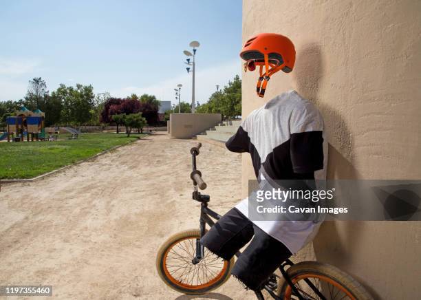 invisible bmx rider relaxing against a wall - photoshop stock pictures, royalty-free photos & images
