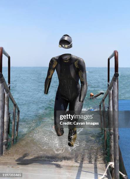 invisible triathlete emerging from the water - photoshop photos et images de collection