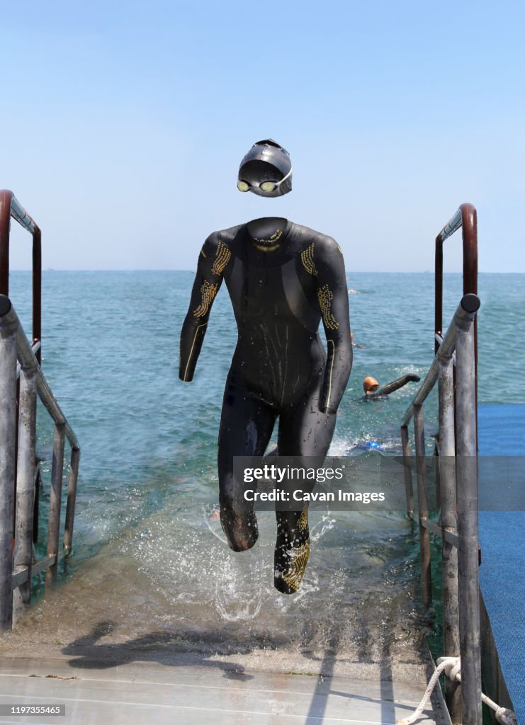 Invisible triathlete emerging from the water