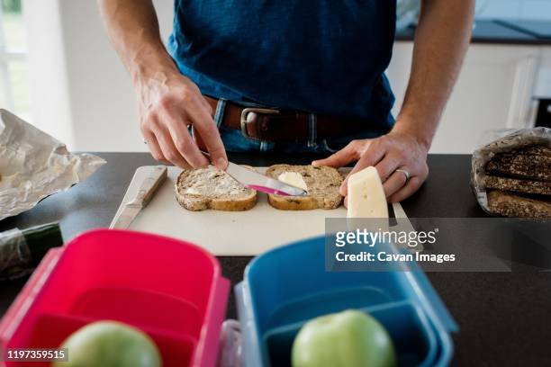 father making a packed lunch for his kids before school - lunch buffet stock pictures, royalty-free photos & images