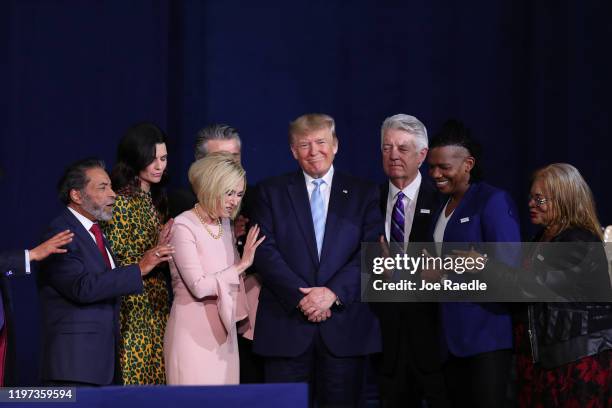 Faith leaders pray over President Donald Trump during a 'Evangelicals for Trump' campaign event held at the King Jesus International Ministry on...