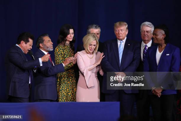Faith leaders pray over President Donald Trump during a 'Evangelicals for Trump' campaign event held at the King Jesus International Ministry on...