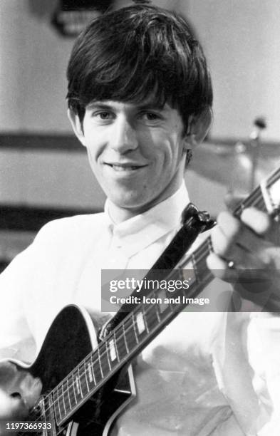 English guitarist, songwriter and co-founder of the Rolling Stones, Keith Richards, plays a Harmony Meteor H70 model guitar at De Lane Lea Studios...