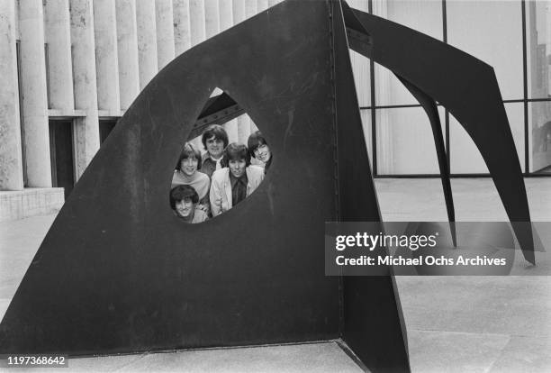 American band the Classics IV, including singer Dennis Yost , posing with the Alexander Calder sculpture 'Le Guichet' in the Lincoln Center Plaza,...