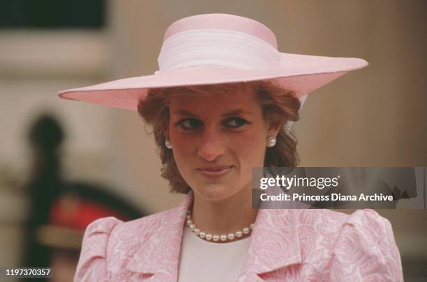 Diana, Princess of Wales wearing a pink suit by Catherine Walker and a matching Philip Somerville hat during a visit to Northampton to receive the...