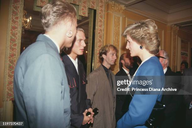 Diana, Princess of Wales meets singers Matt and Luke Goss of pop group Bros at the Cafe Royal in London, during a luncheon to launch Capital Radio's...