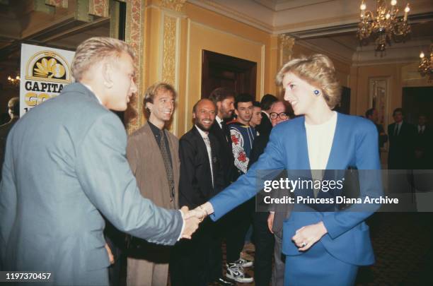 Diana, Princess of Wales meets singer Matt Goss of pop group Bros at the Cafe Royal in London, during a luncheon to launch Capital Radio's Help A...
