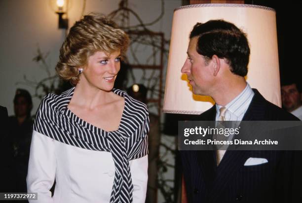 Prince Charles and Diana, Princess of Wales attend a reception at the British Embassy in Abu Dhabi in the United Arab Emirates, March 1989. She is...