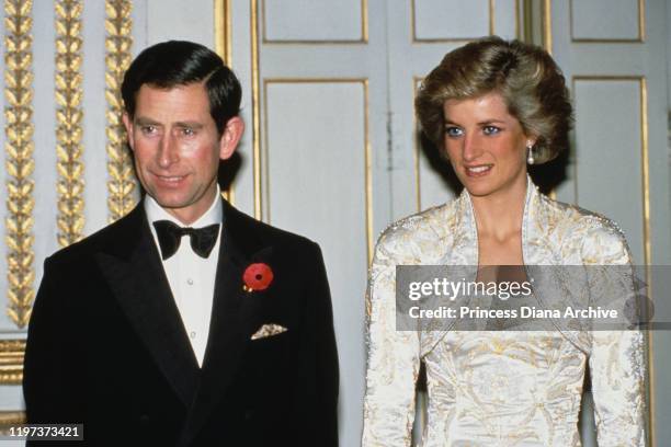 Charles and Diana, Princess of Wales during a dinner at the Élysée Palace in Paris, France, November 1988. Diana is wearing a white gown by Victor...