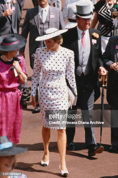 Diana, Princess of Wales attends the Ascot race meeting in England, wearing a black and white spotted dress by Victor Edelstein and a Philip...
