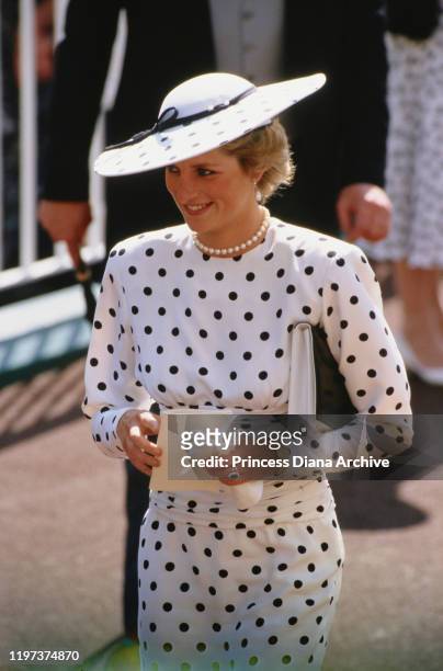 Diana, Princess of Wales attends the Ascot race meeting in England, wearing a black and white spotted dress by Victor Edelstein and a Philip...