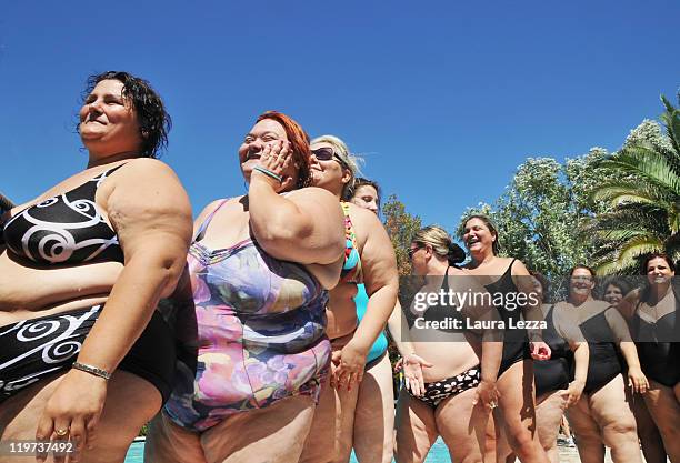 Some participants of 22nd edition of the Italian 'Miss Cicciona' competition line up during the backstage on July 23, 2011 in Pisa, Italy.