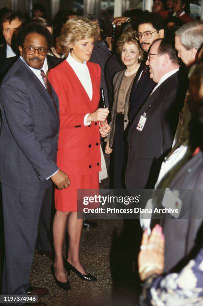 Diana, Princess of Wales wearing a red and white suit by Catherine Walker during a visit to the AIDS unit of Harlem Hospital, New York City, USA,...