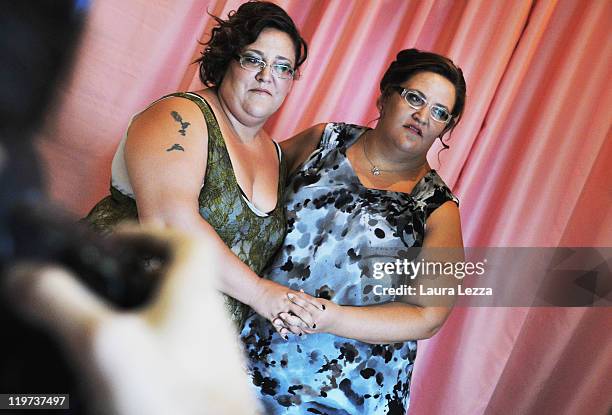 Two twins participants of 22nd edition of the Italian 'Miss Cicciona' competition pose for a photo backstage on July 23, 2011 in Pisa, Italy.