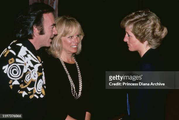 Diana, Princess of Wales meets American singer Neil Diamond and his wife Marcia at a concert at Wembley Stadium in London, November 1989.