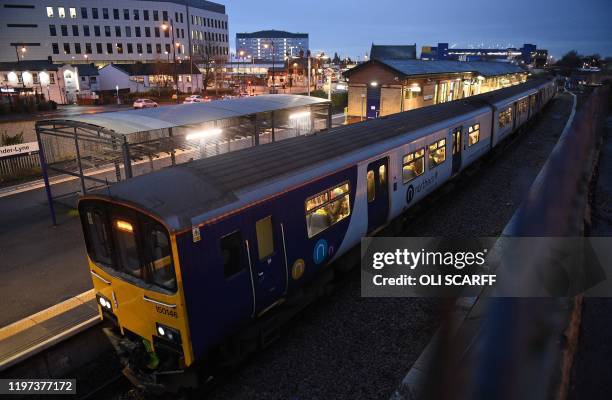 Rail passengers commute on a Northern train, operated by Arriva, a unit of Germany's Deutsche Bahn, as it passes through the train station in...
