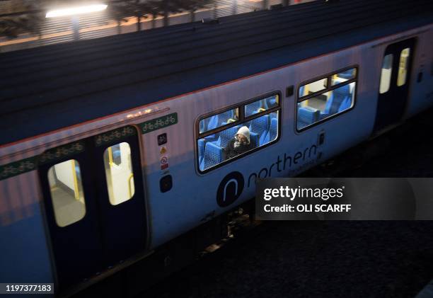 Rail passengers commute on a Northern train, operated by Arriva, a unit of Germany's Deutsche Bahn, as it passes through the train station in...