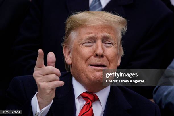 President Donald Trump gestures after signing the United States-Mexico-Canada Trade Agreement during a ceremony on the South Lawn of the White House...