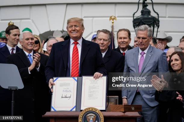 President Donald Trump stands after signing the United States-Mexico-Canada Trade Agreement during a ceremony on the South Lawn of the White House on...