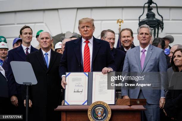 President Donald Trump stands after signing the United States-Mexico-Canada Trade Agreement during a ceremony on the South Lawn of the White House on...