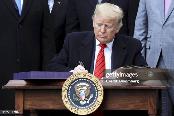 President Donald Trump signs the U.S.-Mexico-Canada Agreement on the South Lawn of the White House in Washington, D.C., U.S., on Wednesday, Jan. 29,...