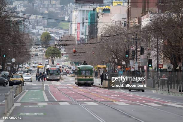 Tram travels alongside vehicles on Market Street in San Francisco, California, U.S., on Wednesday, Jan. 15, 2020. Passenger cars and ride-hailing...