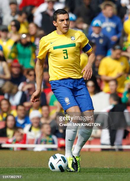Brazil's Captain Lucio runs with the ball during their International friendly football match against Scotland at the Emirates Stadium in London, on...