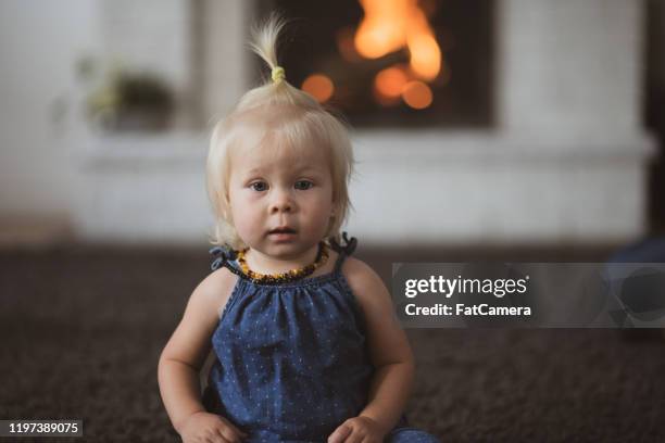 sweet toddler in front of a fireplace stock photo - beautiful blonde babes stock pictures, royalty-free photos & images