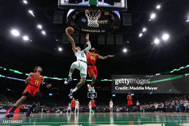 Jayson Tatum of the Boston Celtics takes a shot against DeAndre' Bembry of the Atlanta Hawks at TD Garden on January 03, 2020 in Boston,...