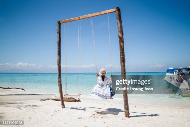 young woman relaxing on beach vacation - kota kinabalu beach stock pictures, royalty-free photos & images