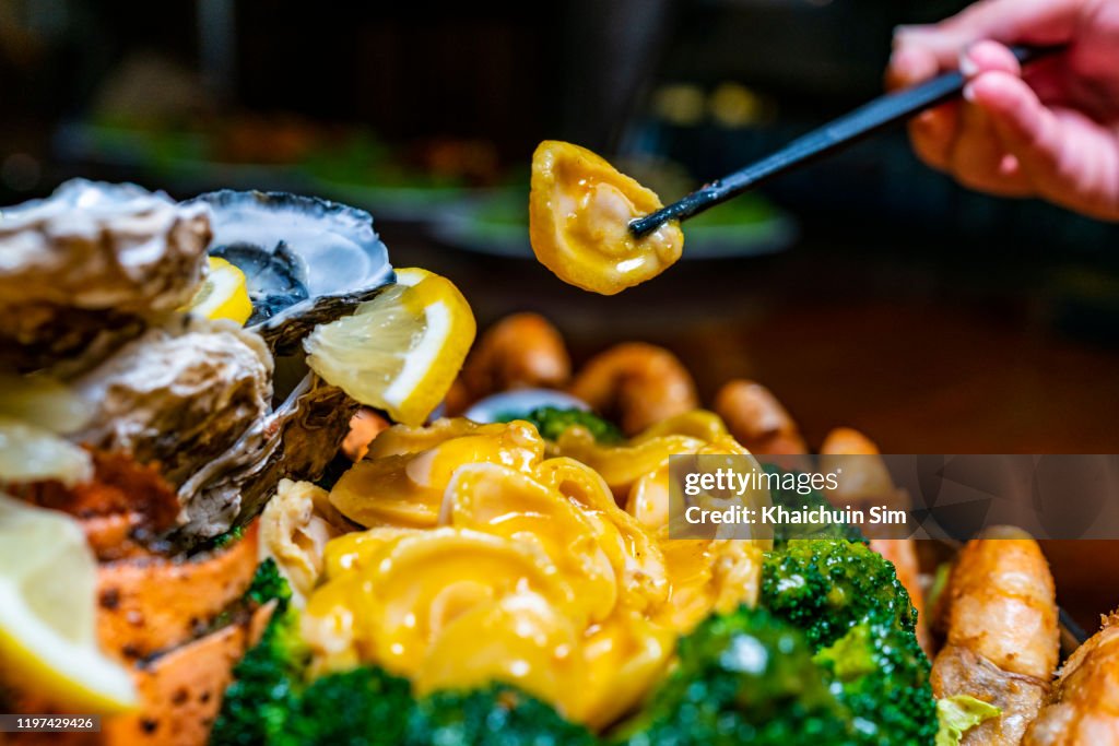 Seafood barbecue platter, focus on abalone